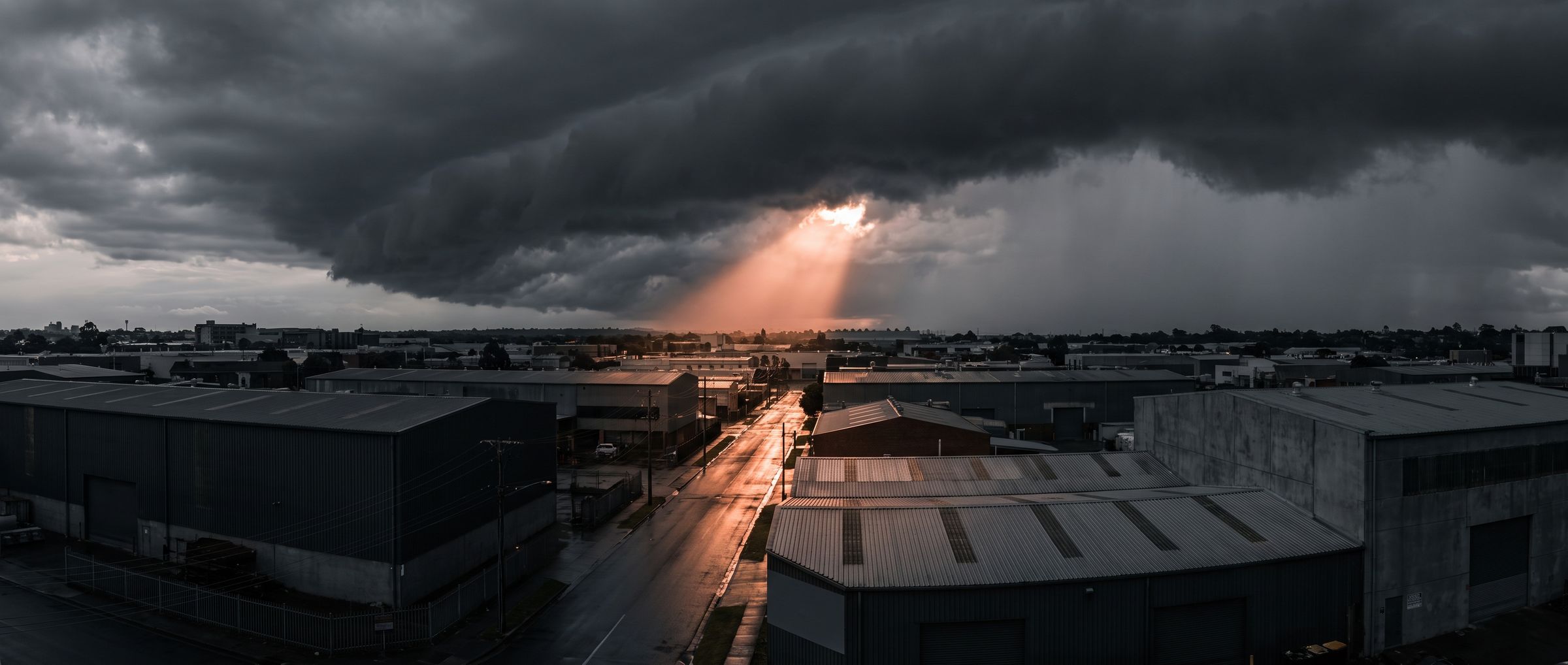 Illustration of storm clouds over a warehouse district